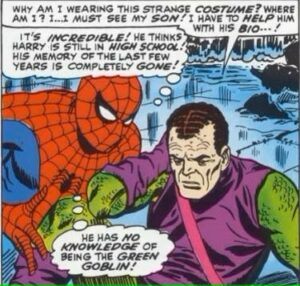 Spider-Man kneels next to unmasked Green Goblin who now has amnesia. 
